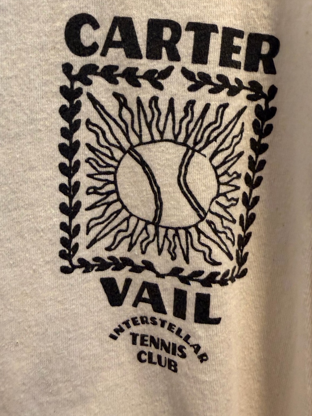 Cartier Cream Long Sleeve Tee with Black Tennis Sun Logo